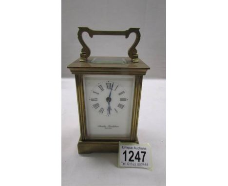 A brass carriage clock in working order but missing key.