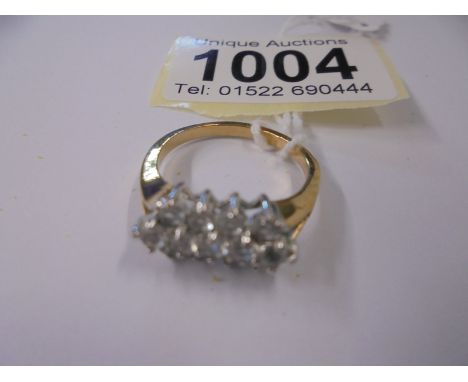 A yellow gold ring set white stones (tests as 9ct), size P half, 2.3 grams.