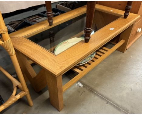 An oak coffee table with insert glass top &amp; magazine shelf