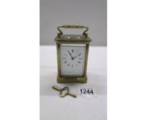 A brass carriage clock in working order and with key.