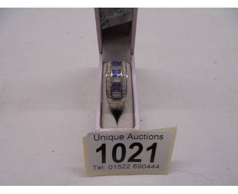 A silver (925) ring set blue stones, size S.