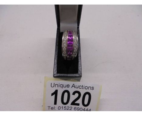 A silver (925) ring set pink stones, size S.