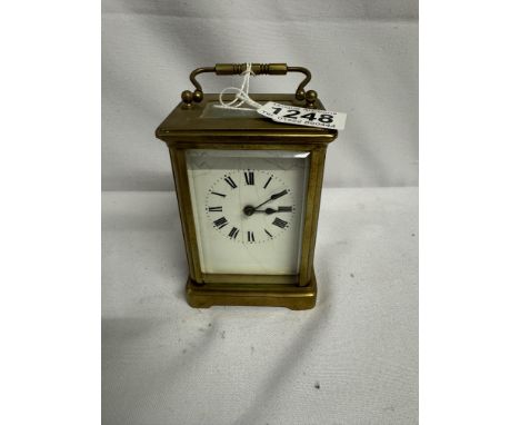 A brass carriage clock in working order but missing key.