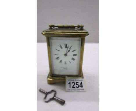 A brass carriage clock in working order and with key.