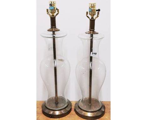 A pair of mid 20th C glass table lamp bases, H. 60cm.