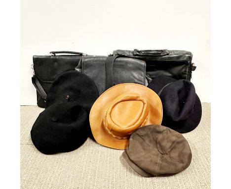 A group of vintage leather bags and hats.