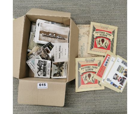 A quantity of vintage postcards, card books and cigarette cards.