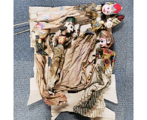 A group of wooden Indonesian stick puppets.