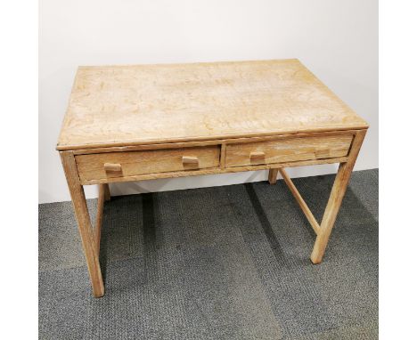 A light oak two drawer writing desk, 103 x 77 x 65cm.