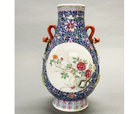 A finely decorated mid 20th C Chinese enamelled porcelain vase, previously drilled as a lamp base and refilled, H. 24cm.