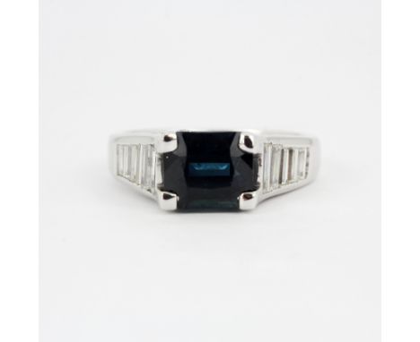 A 14ct white gold (stamped 14K) ring set with a octagon/step cut natural sapphire, approx. 2.34ct, and baguette cut diamonds 