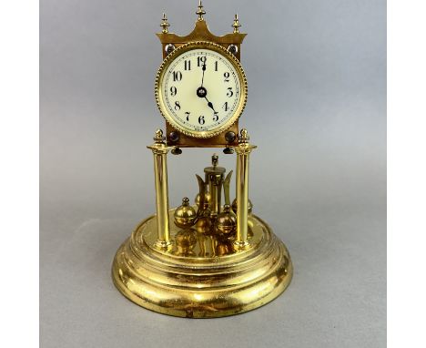 A torsion gilt brass clock under dome, H. 28cm.