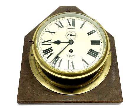 An oak mounted brass Smith Astral ship's style wall clock, H. 39cm.