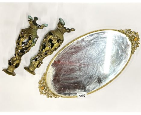 A 1920's mirrored brass tray, W. 46cm, together with a pair of brass candle holders/lamp bases.