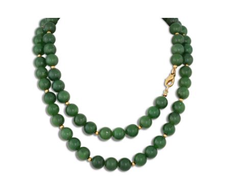 A JADE BEADED NECKLACE, to an 18ct gold clasp