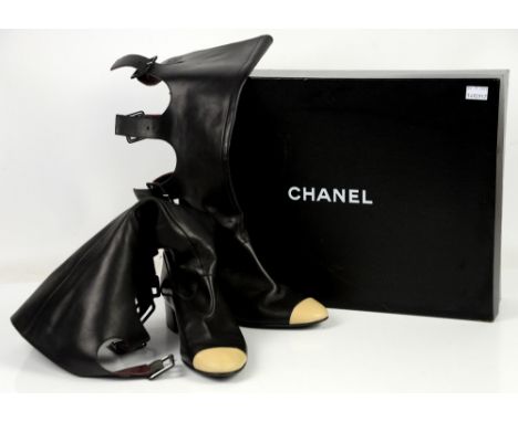 Iconic “cut out” black Chanel leather knee high boots with cream toe caps and 4 buckles at back of calves, with box         C