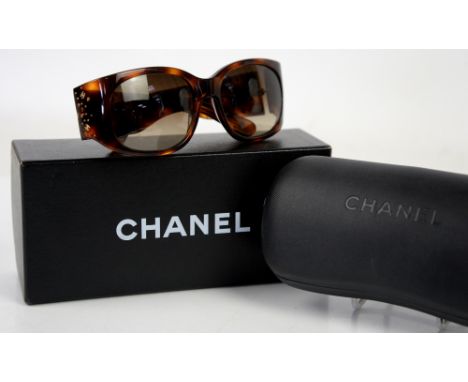 Chanel sunglasses in faux tortoiseshell and diamanté with multiple crossed “CC’s” together with box, hard case and silk clean