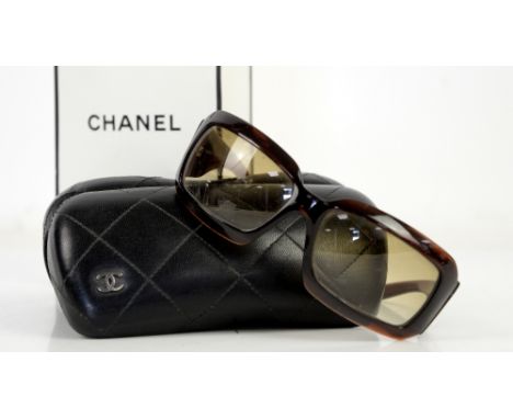 Chanel sunglasses with mother of pearl crossed C’s in hard case and with card and carrier bag         Condition Scratches to 