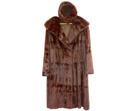 An Ermine brown dyed 3/4 length fur coat with shawl collar with silk lining and a similar fur hat in Harvey Nichols box      