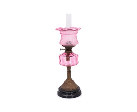 A LATE VICTORIAN DUPLEX TWIN-BURNER OIL LAMP
Fluted brass column base, cranberry glass bowl and etched shade, clear glass flu