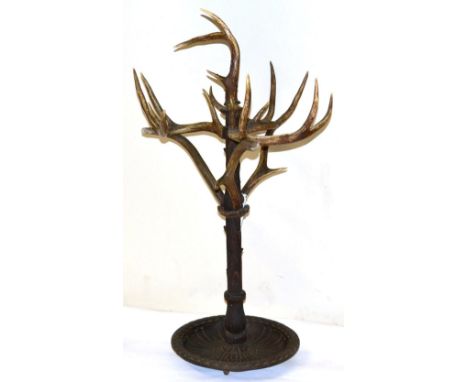 A German Carved Wood, Antler Mounted and Cast Iron Stick and Umbrella Stand, circa 1870-80, the circular dished cast iron bas