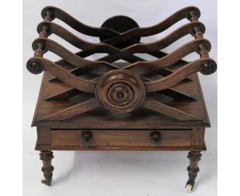 A 19th Century rosewood Canterbury magazine rackThe top with three divided sections and roundel detail, over a single frieze 