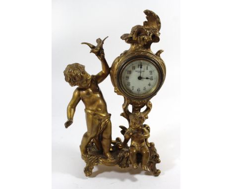 An early 20th Century gilt spelter mantel clockModelled in the form of two children with a bird, inside scrolling decoration 
