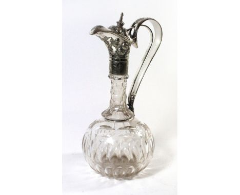 A silver-plated mounted decanterThe decanter with foliate embossed hinged lid and articulated loop handle, height 30cm. 