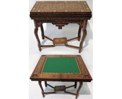 A Syrian Damascus games table Of hinged rectangular form, profusely inlaid with mother of pearl and stained wood in geometric