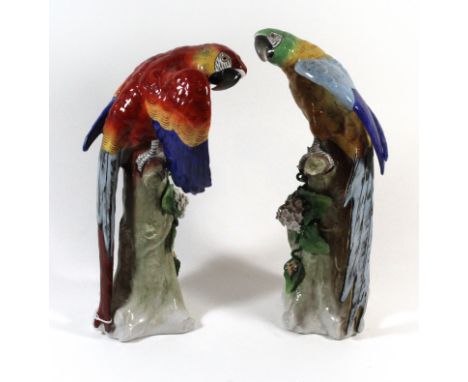 A pair of Sitzendorf porcelain models of Macaw parrotsRaised on naturalistic floral encrusted pedestals, blue printed marks t