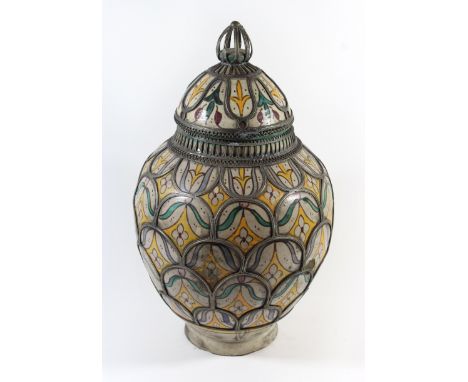 A large North African lidded jarOf tapering circular form, decorated with stylised flowers and overlaid with metal banding, t