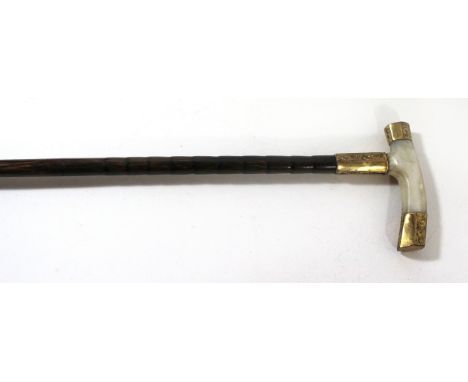 An early 20th Century ladies walking caneHaving mother of pearl handle with 18ct gold mounts and bamboo effect shank, length 