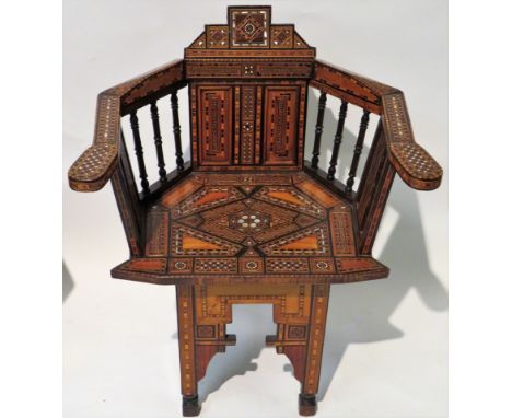 A Syrian Damascus armchairProfusely inlaid with mother of pearl and stained wood, in a geometric pattern, height 80cm, width 