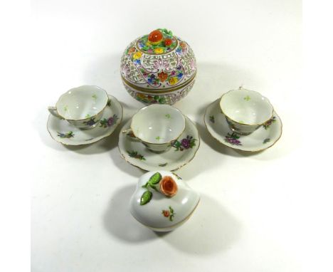 Five pieces of Herend Hungarian porcelainTo include three cups and saucers having hand painted floral decoration, pierced pot