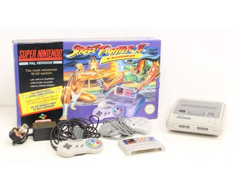 Nintendo: A boxed Super Nintendo Entertainment System (SNES), PAL Version, containing console, one SNES controller and one ot