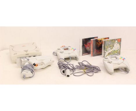 Sega: An unboxed Sega Dreamcast console, NTSC-J, together with two Dreamcast controllers, and gun controller, and three cased