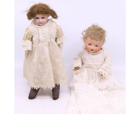 Armand Marseille: A pair of Armand Marseille bisque head dolls, one with a composition body the other stuffed, both with open