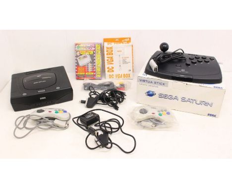 Sega: An unboxed Sega Saturn console, together with two controllers and cables, a boxed Sega Saturn Virtua Stick. Untested fo