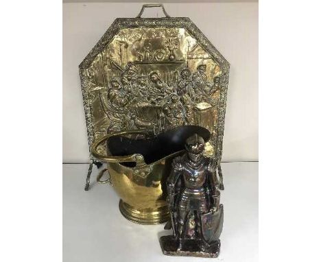 A brass embossed fire screen together with a brass standard lamp and shade, brass coal bucket and companion set