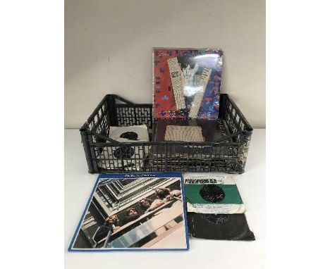 A crate of LP records and 45's all relating to The Beatles inc. Revolver, Hard Days Night, etc and a wallet containing Paul M