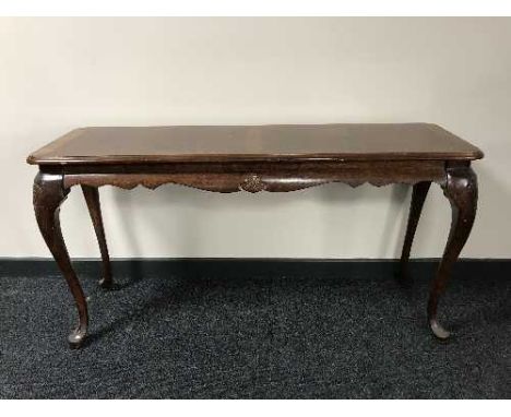 A mahogany console table on ball and claw feet