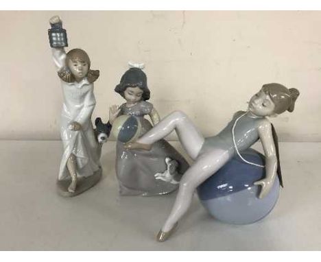 Three Lladro figures - Girl in nightdress with lantern (boxed), together with girl playing with puppy and girl balancing on b