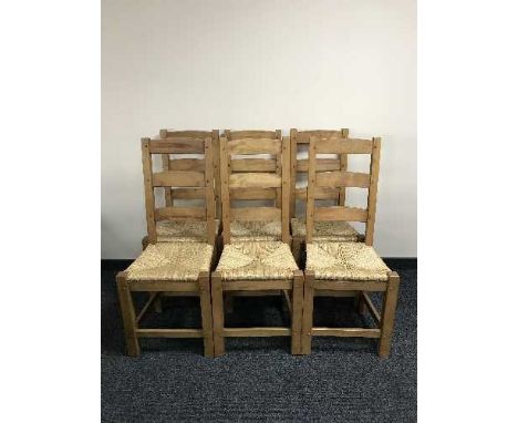A set of six pine rush seated ladder back chairs