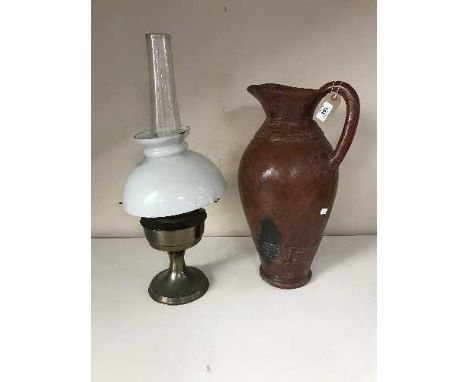 An early 20th century oil lamp with chimney and shade, together with a pottery jug
