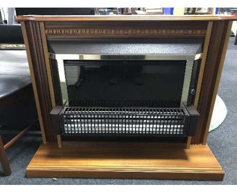 An electric fire in mahogany surround