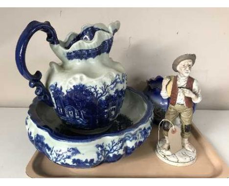 An Ironstone blue and white jug and basin, continental figurine, pottery jardiniere and vase