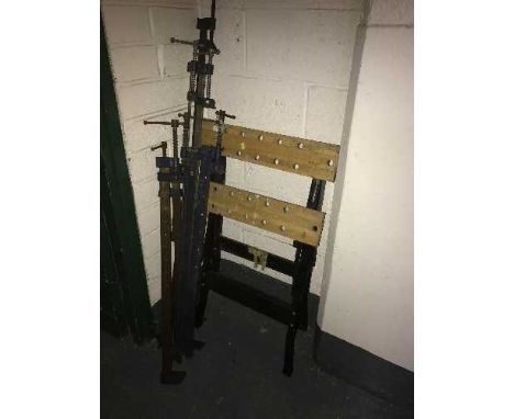 A folding work bench and six sash clamps 