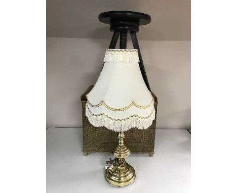 An oak two-tier tea trolley together with a gold loom storage linen box, a circular swivel stool and a brass table lamp and s