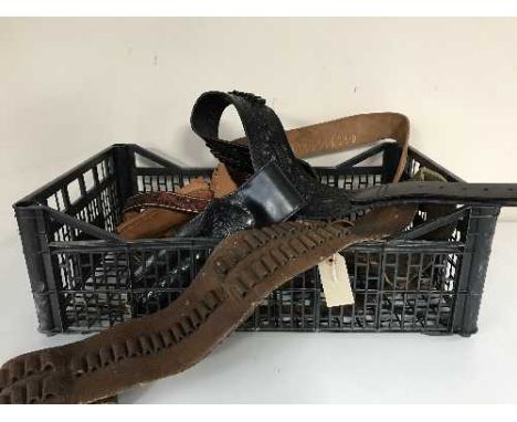 A basket of assorted leather ammunition belts, knife and gun holsters, etc 