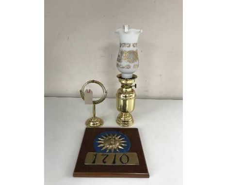 A brass ship's oil lamp with chimney and shade with gimble and Sun Insurance wall plaque